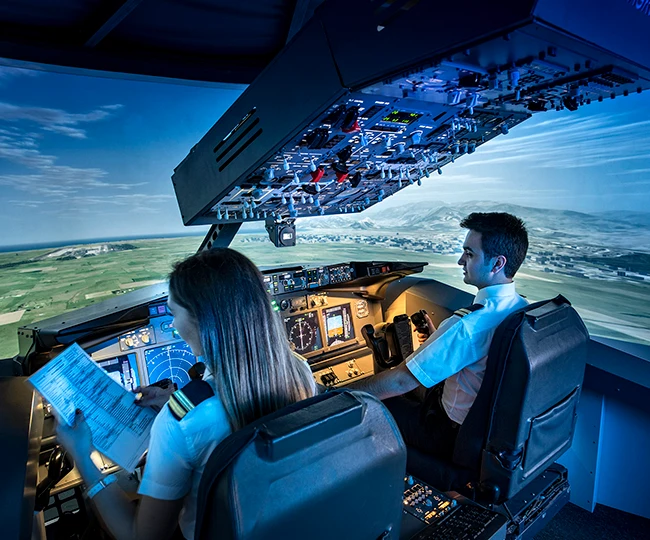 Students standing inside a training airplane on the Özyeğin University campus